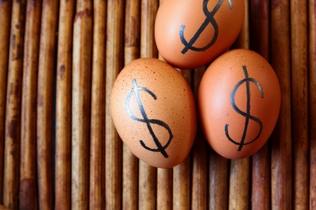 tree eggs on the floor.The dollar sign on eggs.の写真素材