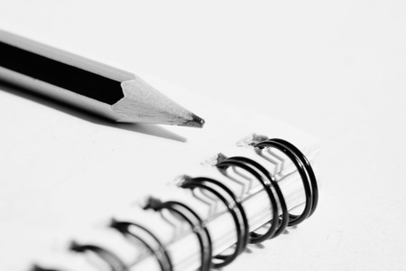 pencil and notebook in composition in black and whiteの写真素材