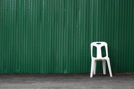 Green zinc and white chairの写真素材