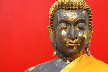buddha statue on red wall