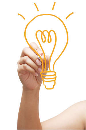 hand with a pen drawing light bulb の写真素材