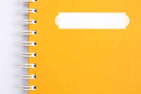 yellow notebook on whiteの写真素材