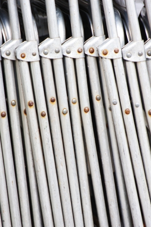 A pile of aluminum chairsの写真素材