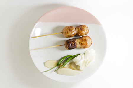 CloseUp, Sausage grill, Two wooden, With chilli, Cabbage,and ginger,On a white plateの写真素材