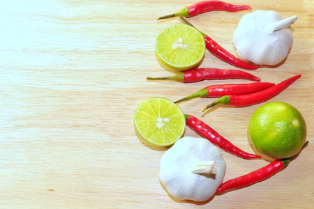 Top view herbs and spices chili lemon garlic on wooden backgroundの写真素材