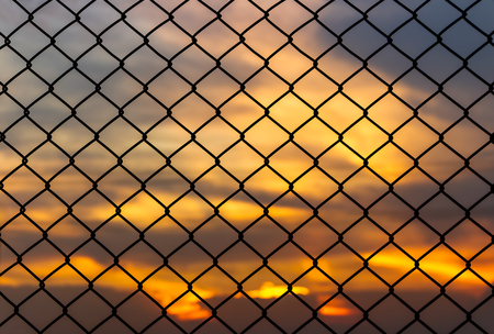 Metal cage square channel on beautiful sunset nature backgroundの写真素材