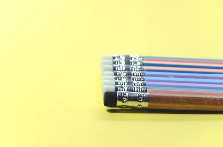 Closeup concept of a Group pencil with a single black eraser Placed on a yellow note bookの写真素材