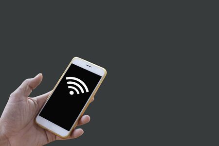 Closeup of men hands, businessman holding a smartphone with a clean black screen and signal wifi...