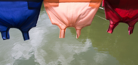 Thai T-Shirt Hanging on a Wire near a Poolの写真素材