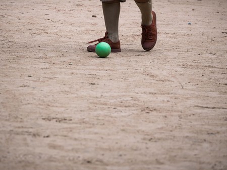 Boyscout Playing Small Green Ball in The Parkの写真素材