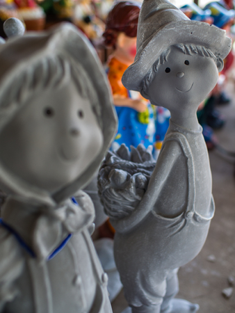 Grey Boy Doll Holding a Bread Basket on The Backの写真素材
