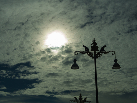 The Power Poles are a Statue of Elephants and Angels Behind The Sunの写真素材