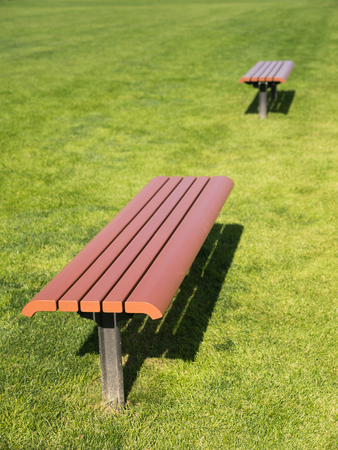 Side View of The Brown Long Chair on The Lawn in The Parkの写真素材