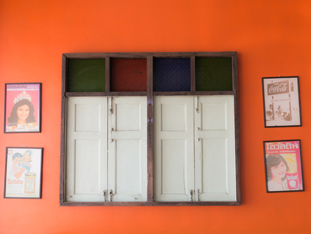 The Orange Old Home Vintage wall , Antique Wooden Top Stained Glass round Window is Old Advertising Pictureのeditorial素材