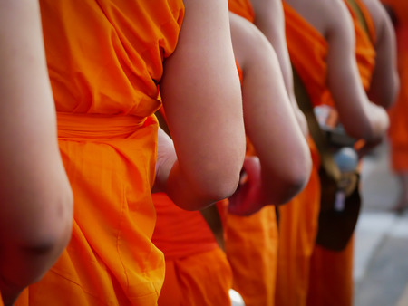 Back of The Monk Holding The Bowl Walking in The Lineの写真素材