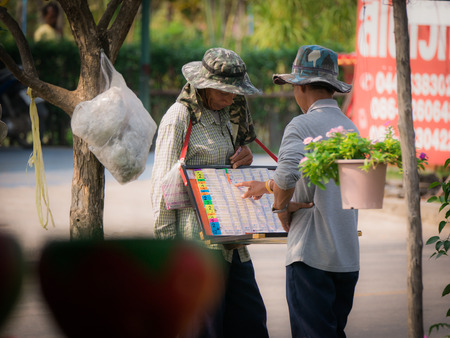 Garden Worker is Choosing The Lottery Salesmanのeditorial素材