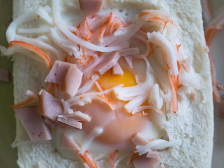 The Rare Egg Fried inside The Bread Sanwich , Garnish with Crab Sticks and Carbonaraの写真素材
