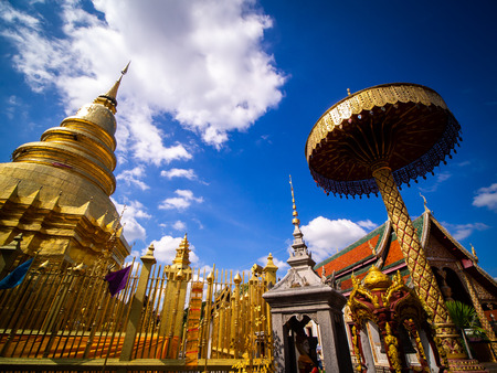 The Golden Pagoda near The Church at Wat Chai Lamphun Thailandのeditorial素材