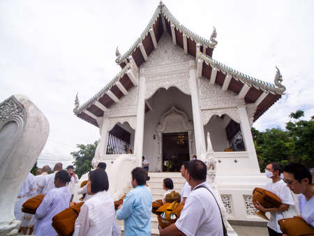 27 June'20 Lamphun Province Thailand : Men Wearing A White Dress Walking before Ordination and Men's Cousin Followed around The Church with Alms-bowl and Yellow Robeのeditorial素材