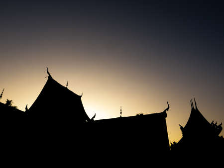 The Silhouette Buddhist Church in The Dark Shadow behind The Sunset Lightの写真素材