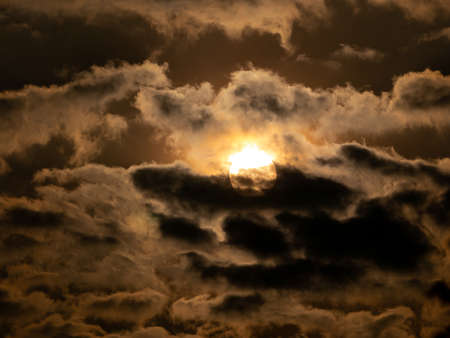 The Sun Rising on a Cloudy Day in Yellow Backgroundの写真素材