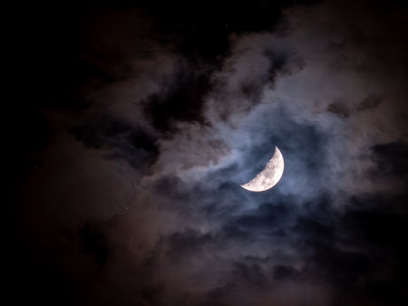 The soft glow of the moon illuminates the surrounding darkness, creating a tranquil and mystical...