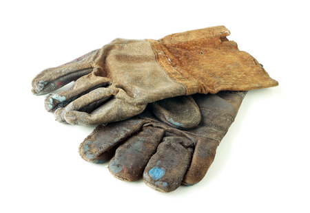 Old Dirty Leather Gloves on white backgroundの写真素材