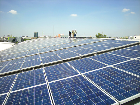 Solar PV Rooftop with Workers Walkingの写真素材