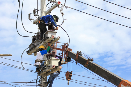 Technicians Working on Electrical Poleの写真素材
