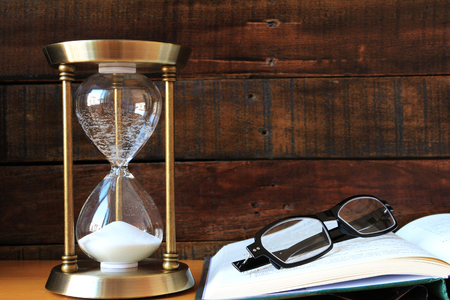 Sandglass with Book and Eyeglassesの写真素材