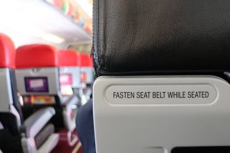 Warning Signs on Airplane Fasten Seat Belt While Seatedの写真素材