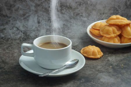 Hot cappuccino coffee cup and Thai Egg Cake , sweet thai (Blurred or blurry)