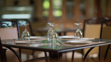 Restaurant table with tableware and silverwareの写真素材