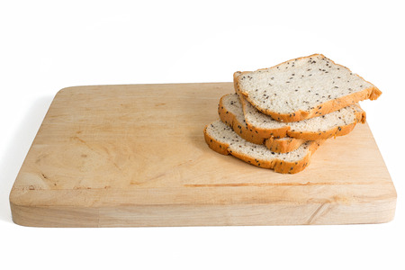 Sesame bread sheets on wooden cutting board