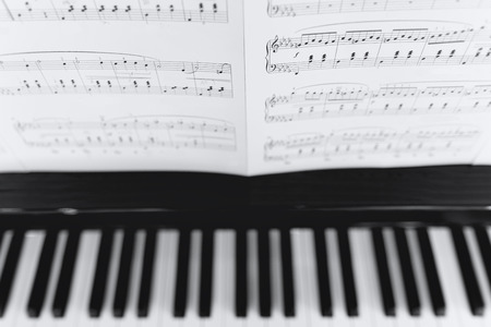 Piano and a Musical note with shallow focus on the noteの写真素材