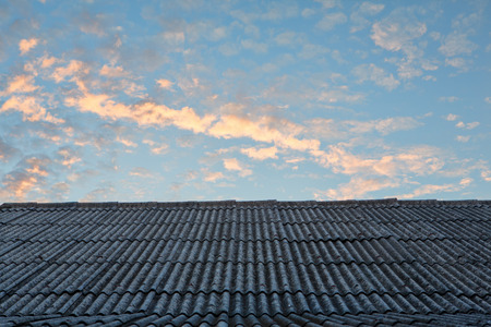 Old roof with blue sky and nice cloud at sunriseの写真素材