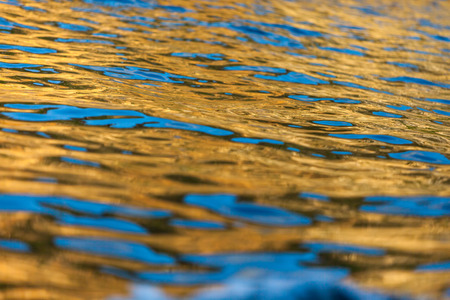 Texture of vivid color shining sunset and building reflected on the sea surfaceの写真素材