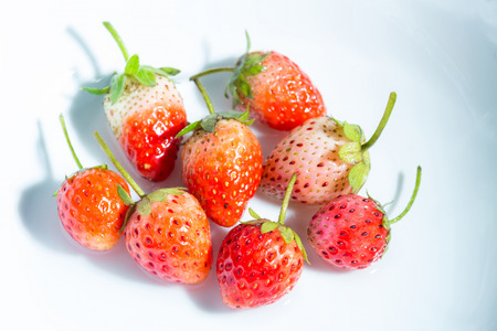 Strawberry in a small clear glass on white backgroundの写真素材