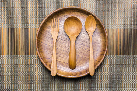 Dinning utensil set up on a green weaved bamboo mat