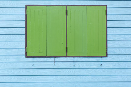 Picture of an outdoor exterior of an old wooden house with colorful paintの写真素材