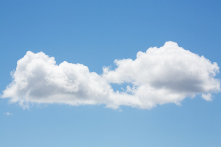 white fluffy clouds with clear blue skyの写真素材