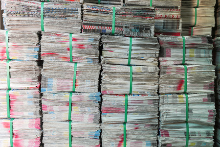 Stack of newspaper ready for sales , used for wrapping, in the fresh market , Bangkok, Thailand