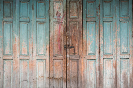 Folding wooden door frame with stained color in countryside.の写真素材