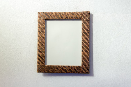 Retro style wooden picture frame hanged  on white wallの写真素材