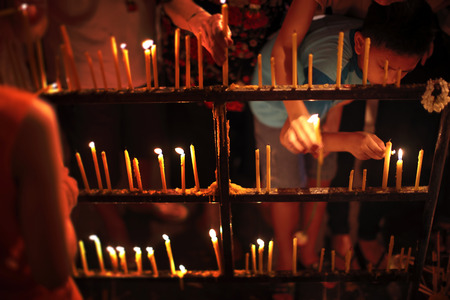 Bangkok, Thailand - July 3, 2012: Thai buddhists lighting the candles to pay respect to the buddha at Wat Benchamabophit at night before they do the triple circumambulationin in Wisakha Bucha dayのeditorial素材