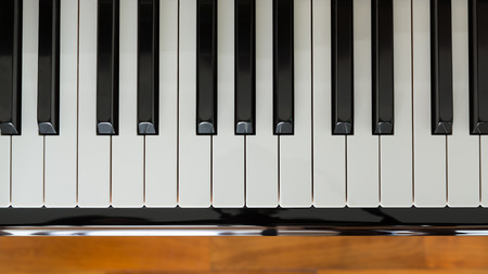 Close up of Piano keyboard with wooden floor background.の写真素材