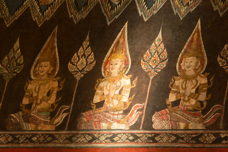 Water color painting of guardian angles on wall in ancient temple in Bangkok in sunlight, Thailandのeditorial素材