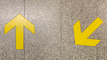 Arrow signs used to guide the direction in the underground train station.の写真素材