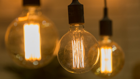 Vintage style light bulbs hang and decorated in a living room.