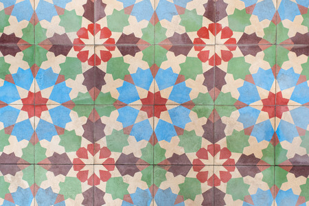 Ancient floor tiles with colorful flower pattern.